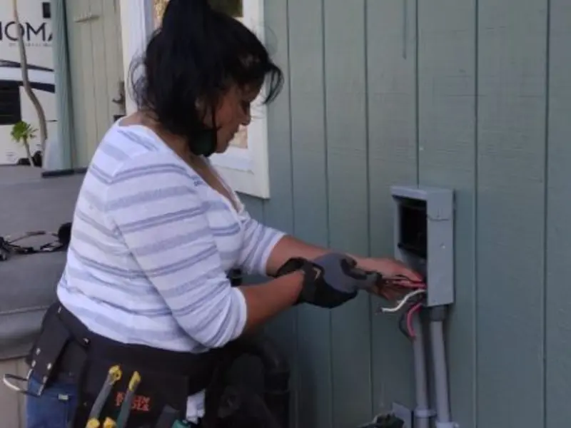 Licensed electrician wiring an exterior subpanel in Timnath